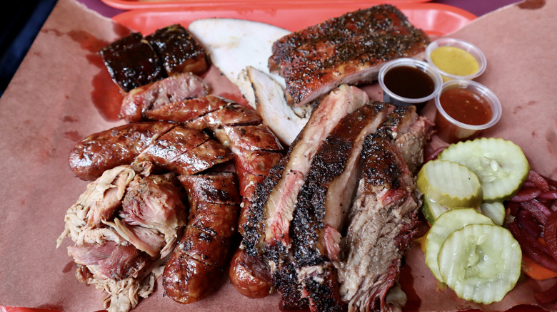 barbecue tray with pulled pork, ribs, turkey, sausages, and more