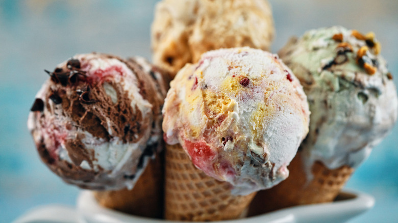 Four different flavors of ice cream in cones