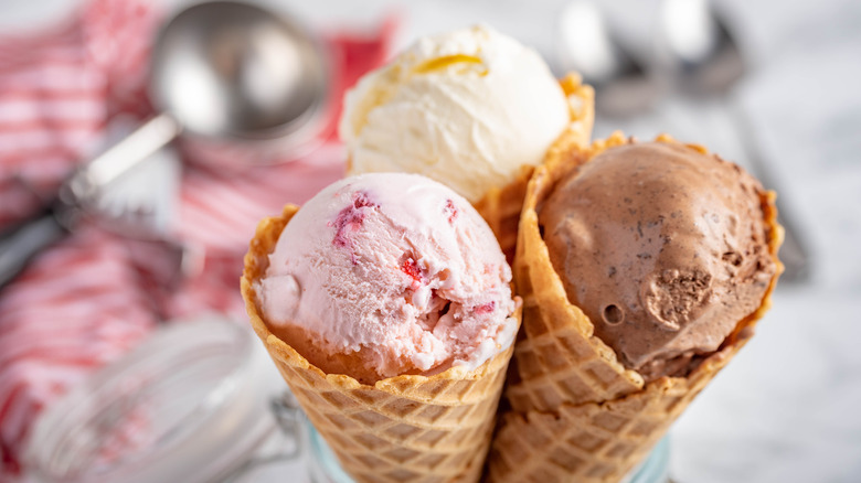 Three scoops of ice cream in waffle cones