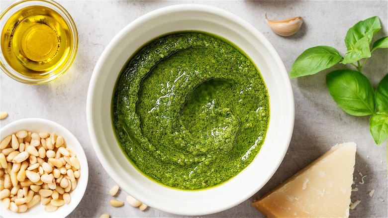 prepared pesto with ingredients