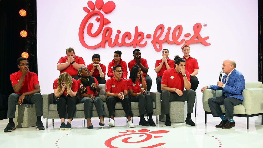 Chick-fil-A CEO Dan T. Cathy sitting on a stage with employees