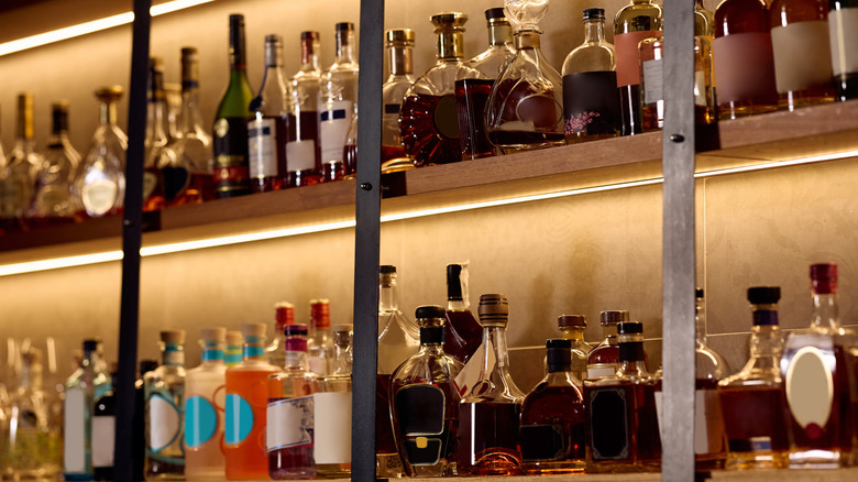 Various bottles of liquor on large bar.