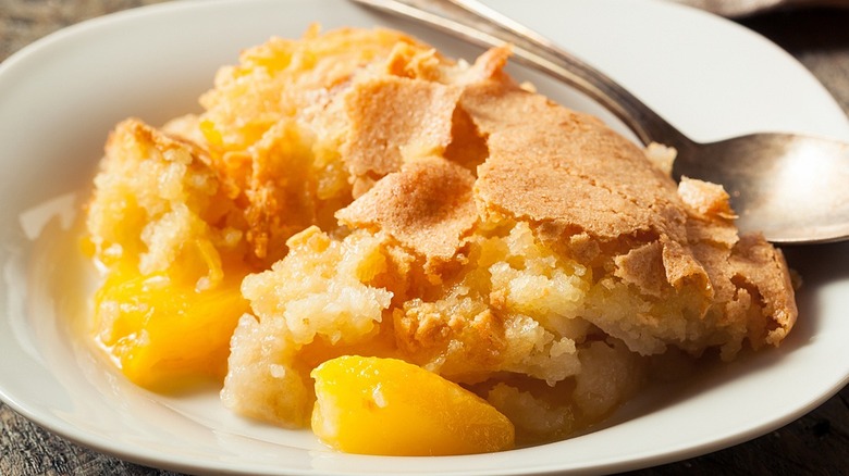 Peach cobbler in bowl with spoon