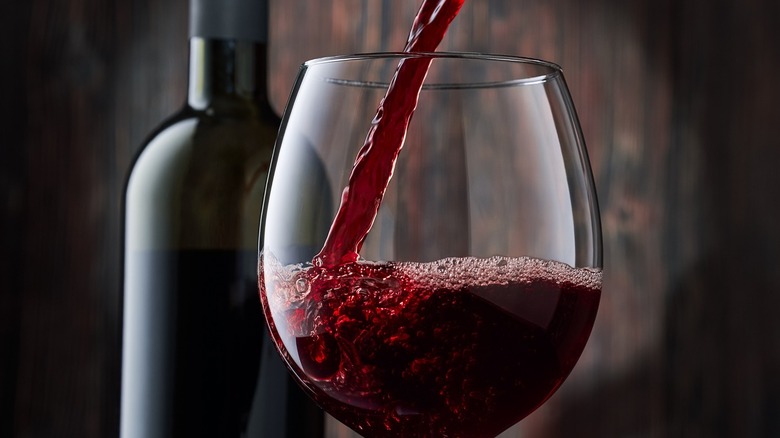 red wine being poured into a glass