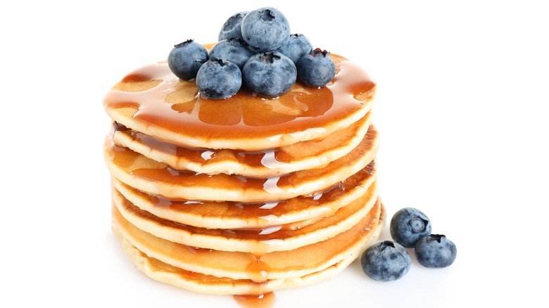 Stack of pancakes with syrup and blueberries