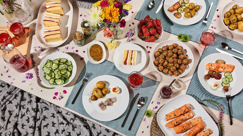 Table covered with many various food dishes and drinks