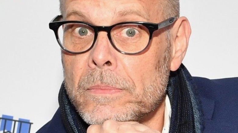 Alton Brown with glasses and serious expression