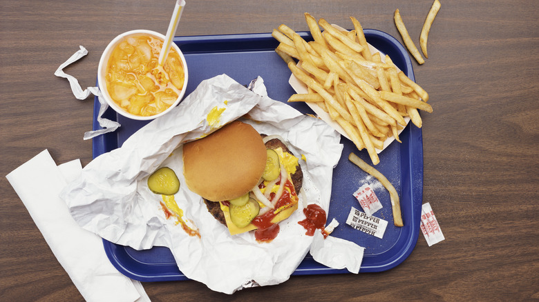 Fast food hamburger, fries, and drink on tray