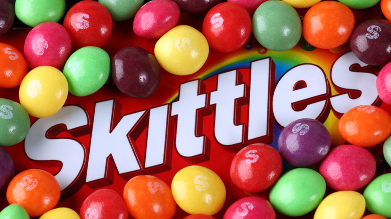 Skittles bag with loose candies on top