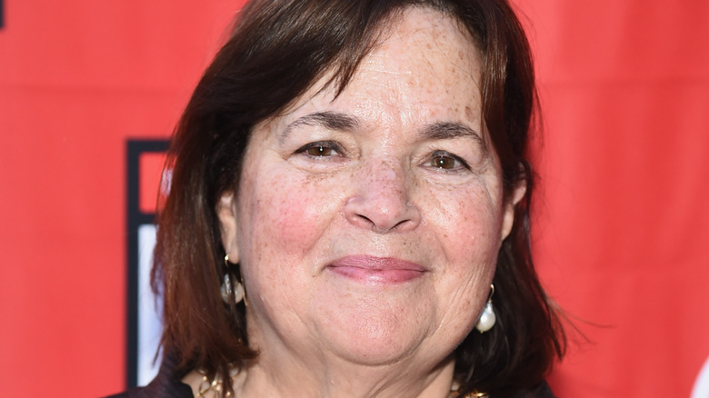 Ina Garten smiling with red background