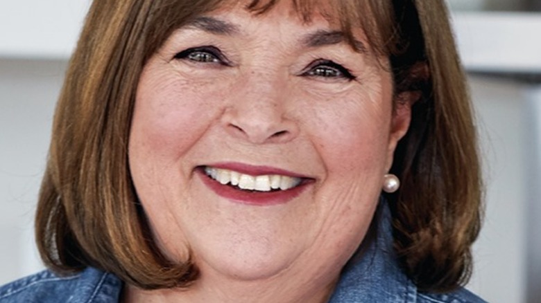 Ina Garten wearing denim top and pearl earrings