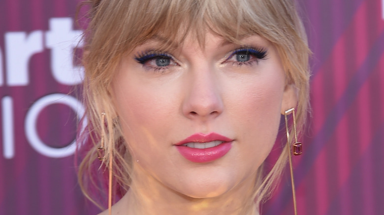 Taylor Swift looking to the side with pensive expression