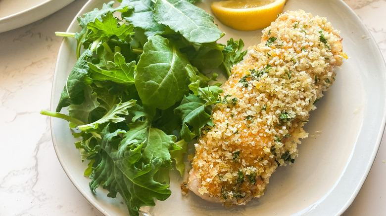 panko covered salmon on plate with salad