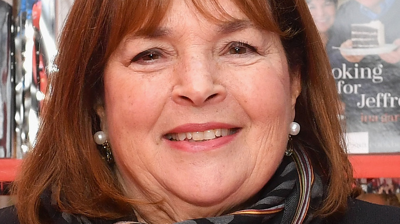 Ina Garten smiling in front of a display of her books