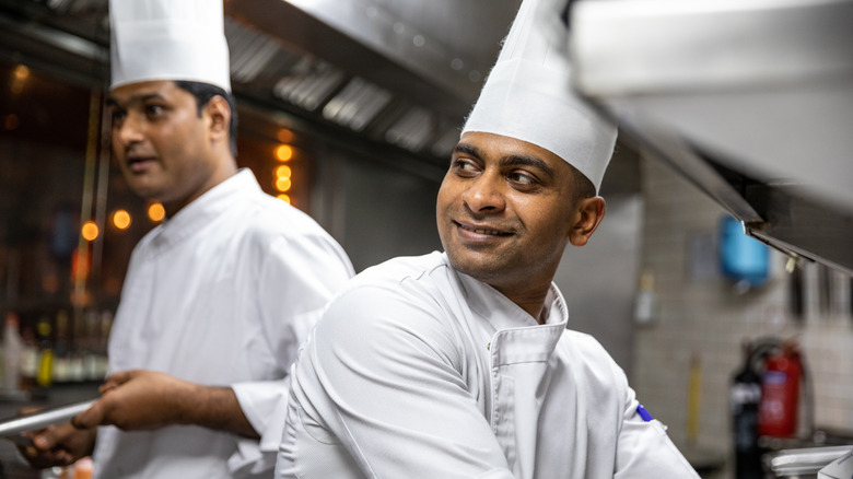 chefs cooking in professional kitchen