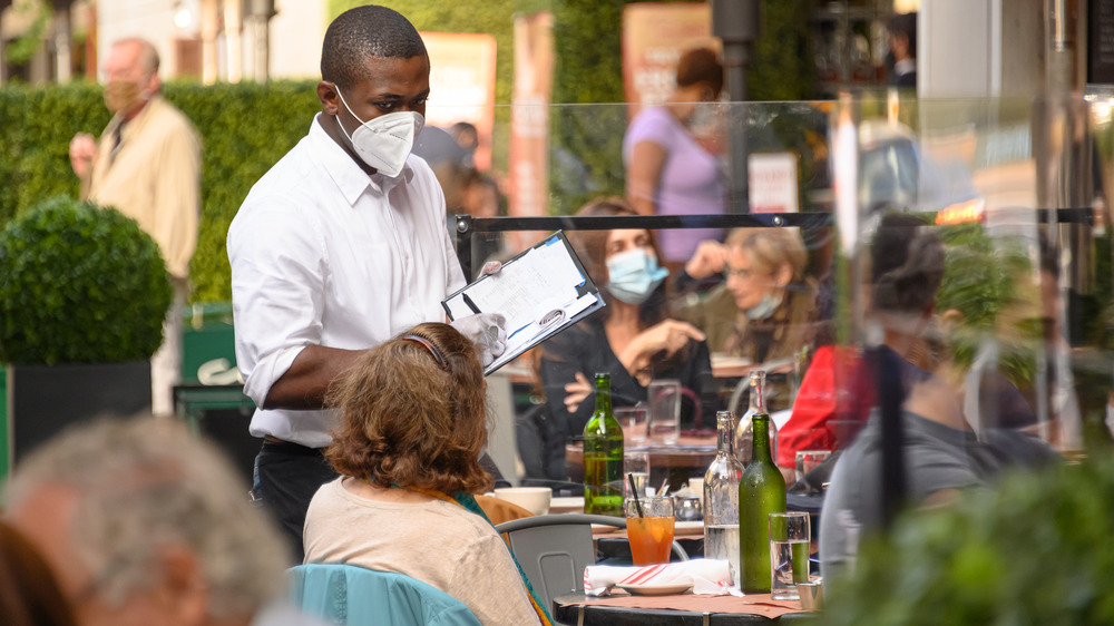 Waiter wearing a mask