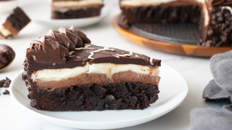 slice of chocolate-frosted cake on a white plate