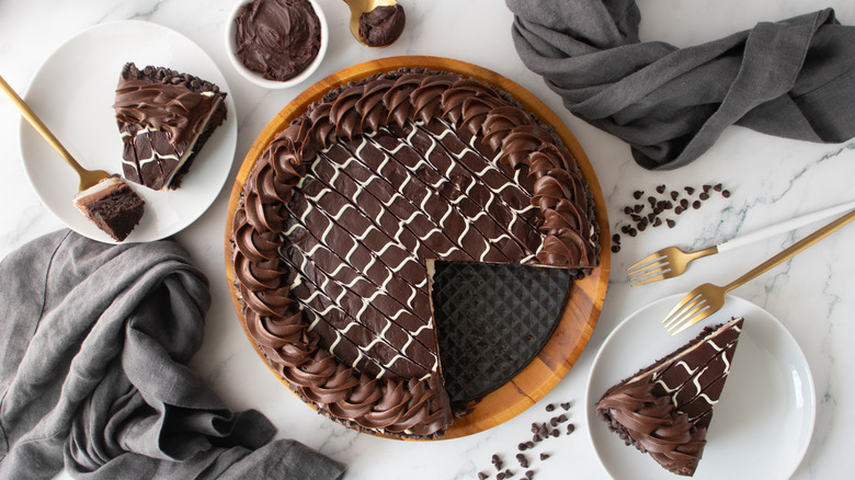 chocolate-frosted cake with one missing slice