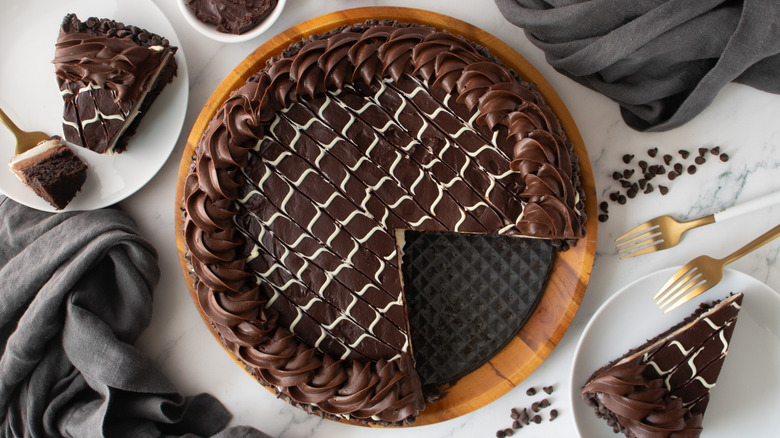 chocolate-frosted cake with one missing slice