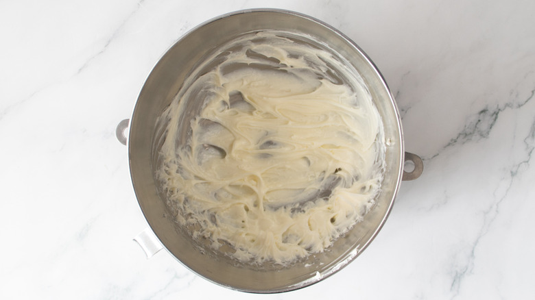 white frosting in a metal bowl