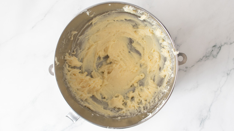 white frosting in a metal bowl