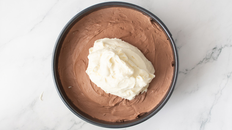 white frosting on top of cake with light brown frosting