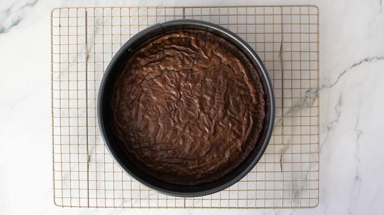 Baked brownie in can pan on wire rack