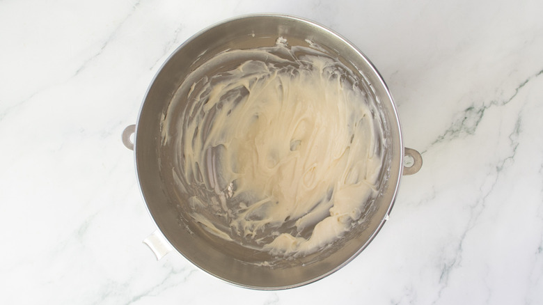 white frosting in a metal bowl