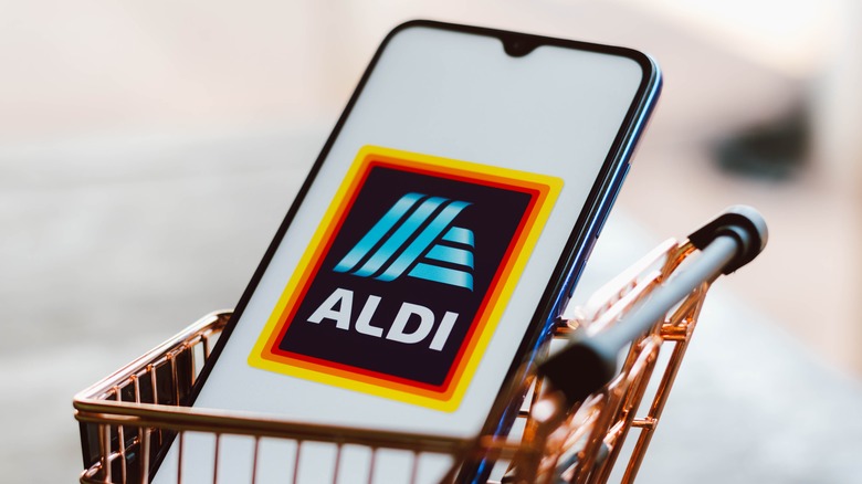 smartphone with Aldi app in cart