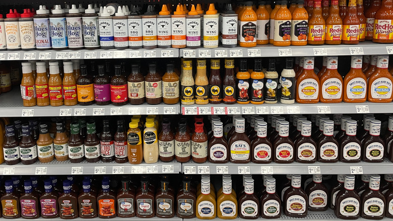 Rows of barbecue sauces at the grocery store.