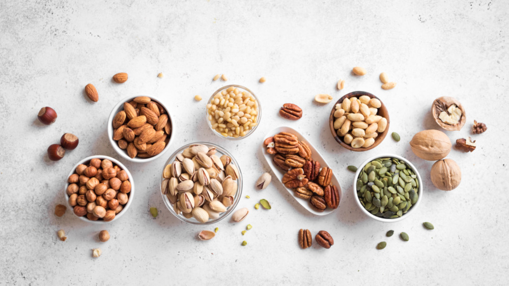 assorted nuts including almonds, pistachios, walnuts, sunflower seeds and peanuts