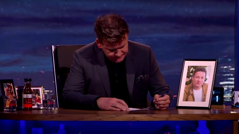Gordon Ramsay writing on desk