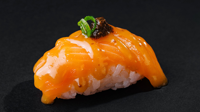 Close up of salmon sushi topped with roe