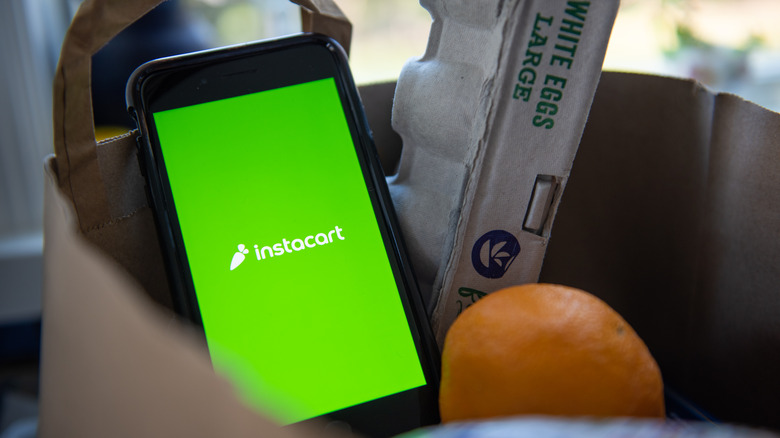 Instacart phone in a bag of groceries