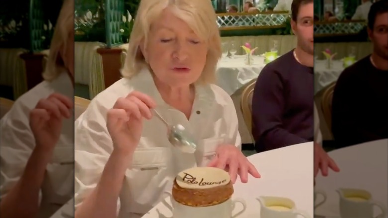 A screen grab of a video of Martha Stewart eating a soufflé 