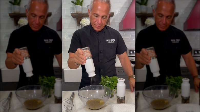 Geoffrey Zakarian sprinkling salt into his salad dressing