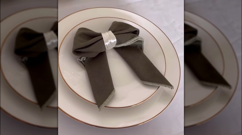 green bow-shaped napkin with white ribbon