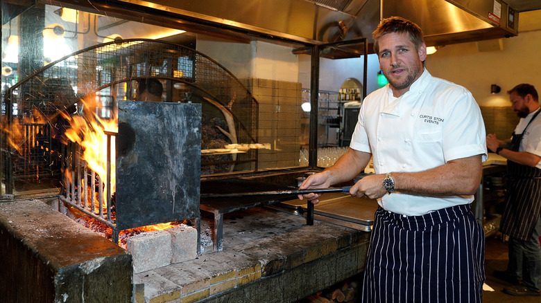 Curtis Stone standing near fire