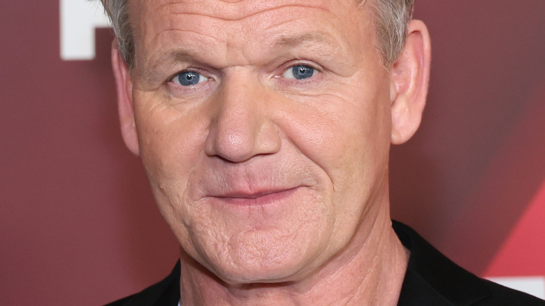 Gordon Ramsay with slight smile in white t-shirt and suit jacket