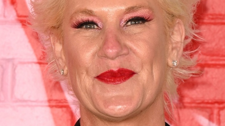 anne burrell smiles with red lipstick 