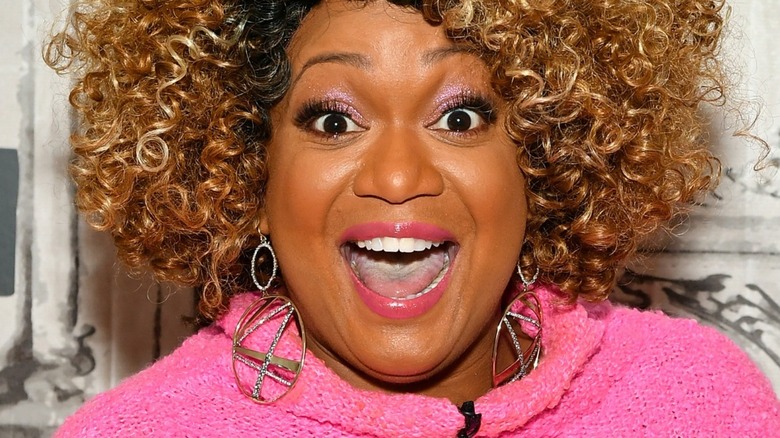 Sunny Anderson smiling with earrings
