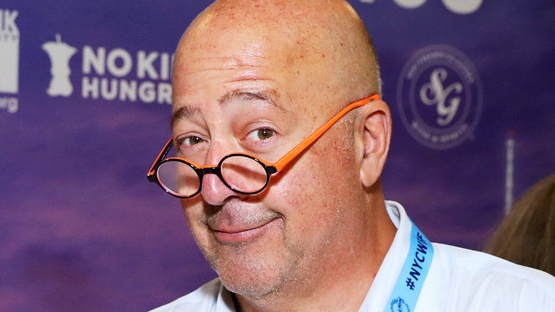 Andrew Zimmern wearing orange glasses