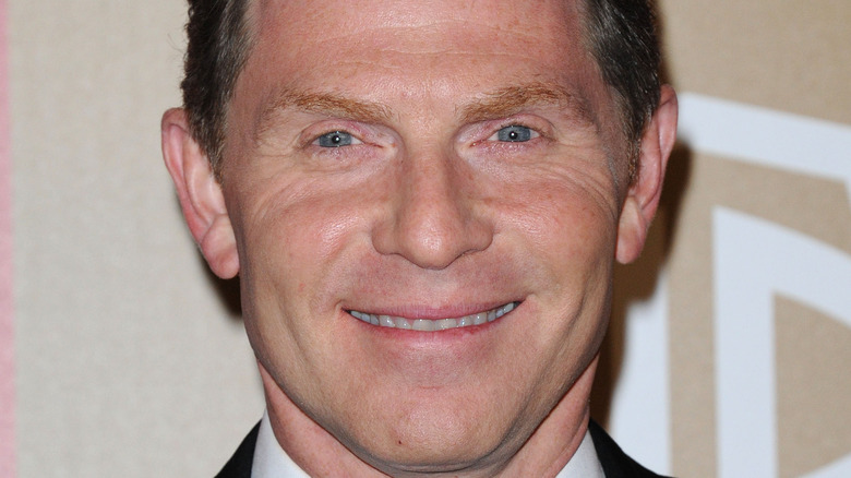 Bobby Flay smiling on red carpet