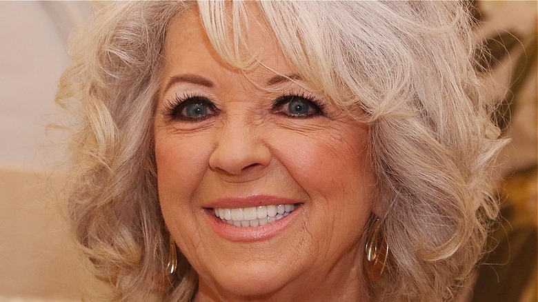 Paula Deen smiles with gold earrings