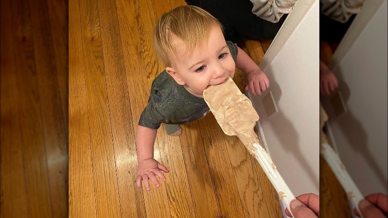 Duff Goldman's daughter, Josephine, licking ice cream off a spatula.