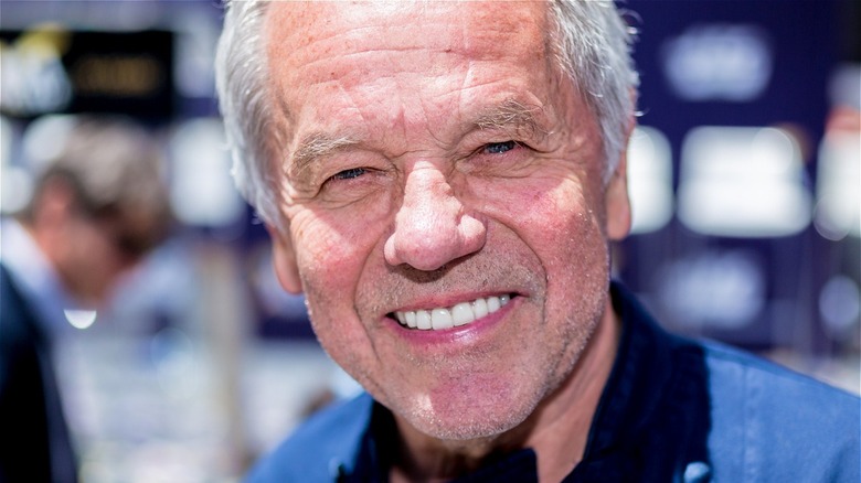 Closeup of Wolfgang Puck in blue and black top