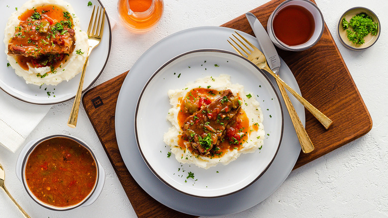 Swiss steak served with mashed potatoes and parsley garnish