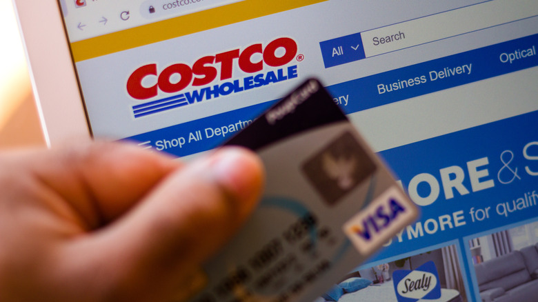 Costco in the background, credit card in the foreground