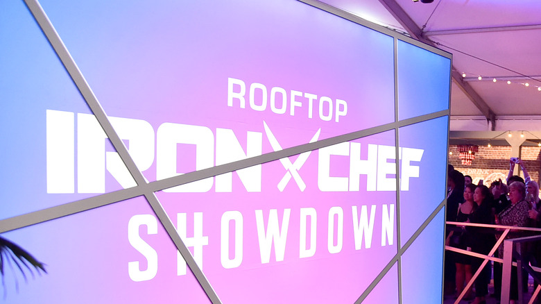 pink and blue sign with "Rooftop Iron Chef Showdown" in white letters