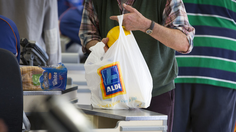 Person bagging Aldi items